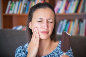 Woman portrait feeling tooth pain at home