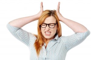 Young woman having severe headache, studio shot